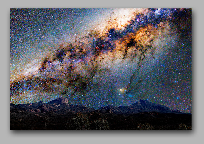 a Volcanic mountain landscape backdropped by our Galaxy
